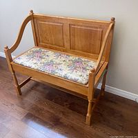 Front view of wooden bench with floral cushion