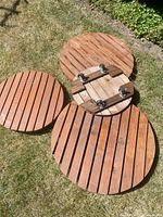 All four wooden circular risers top view on grass