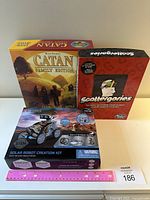 Three boxed items: Catan Family Edition, Scattergories, and Solar Robot Creation Kit