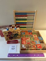 Full set showing wooden abacus, honeycomb beehive fine motor skill set, and wooden alphabet and number blocks in a tray.