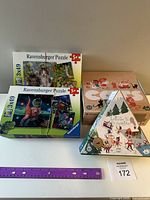 Photo of four boxed puzzles including two Ravensburger 3x49 piece puzzles and two Londji puzzles in original packaging