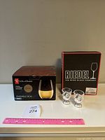Box of 4 PC stemless glasses, two glass chicken egg cups, Riedel Cabernet wine glasses box visible.