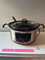 Front view of Hamilton Beach programmable slow cooker with digital control panel and temperature probe inserted, showing screen and buttons.