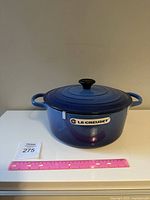 Front view of blue enameled Dutch oven with lid and Le Creuset badge