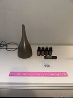 Complete setup of Saje diffuser with diffuser unit, essential oils, roll-on, and label number