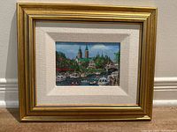 Front view of framed oil painting showing artwork, mat, and gold frame