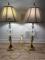 Full view of both cut crystal brass lamps with shades