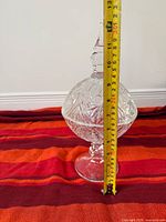 Full view of compote with lid and tape measure showing height