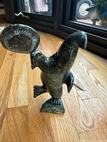 Front view of soapstone seal sculpture holding drum and stick