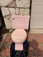 Front view of pink porcelain toilet assembled