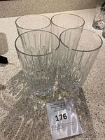Four clear Marquis by Waterford Markham highball glasses showing vertical cut pattern and solid bases, no visible cracks or chips.