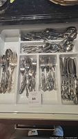 Tray of assorted Towle Supreme Romance pattern cutlery including forks, knives, spoons and serving utensils.