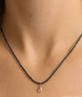 Model wearing necklace showing fit at collarbone