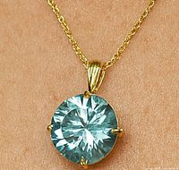 Front view of pendant on model wearing a rope chain, showing moissanite color and cut.