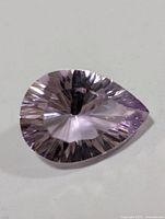 Top view showing pear-shaped, faceted amethyst with light purple color and clear clarity.