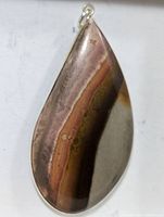 Close-up photo of the teardrop-shaped pendant showing natural multicolored gemstone with distinct banding and polished silver bail.