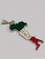 Photo of silver pendant shaped like Italy map with green, white, and red enamel and 'ITALY' inscription