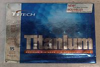Photo of front side of titanium golf ball packaging by TiTech showing branding and product details.