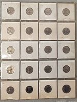 20 Canadian 5 cent coins arranged in rows, each inside individual cardboard coin holders showing front and back sides with date markings visible.