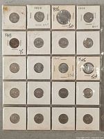 Photo showing twenty Canadian 5 cent coins in individual holders with dates marked, showing some patina and wear.