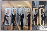 Front of the collector's box with gold embossed Bond 50 and silhouettes of James Bond actors from different eras.