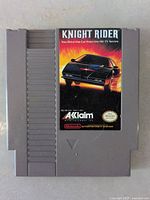 Front view of the gray plastic Nintendo NES cartridge showing label with Knight Rider game artwork and Acclaim logo.