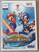 Front cover of the Wii game case showing Mario and Sonic on skis and snowboard, with Olympic Winter Games branding.