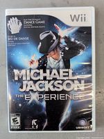 Front cover of Michael Jackson: The Experience Wii game showing Michael Jackson in dancer pose with visual effects.