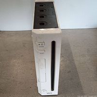 Front view of white Nintendo Wii game console showing disc slot and power buttons