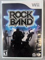 Front cover of Rock Band Wii game showing band silhouettes and logo