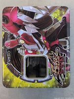 Metal storage tin with Yu-Gi-Oh! Duel Monsters artwork on the lid, showing Turbo Warrior character in red and black armor.