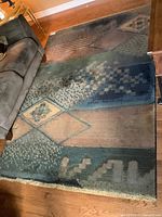 Full view of the rectangular area rug showing pattern and condition.