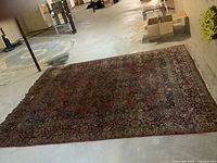 Full view of the 12 × 9 ft rug laid flat on concrete basement floor