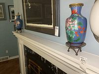 Pair of blue floral cloisonné vases displayed on a white shelf over a fireplace showing overall size and appearance.