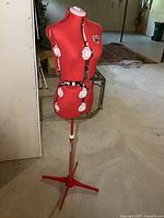 Full view of the Singer adjustable dress form on tripod stand in a basement setting.