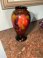 Front view showing overall shape and hand-painted tubelined grape and leaf design