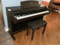 Full front view of piano and bench in room setting