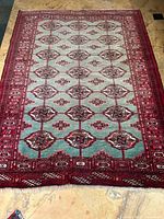 Full view of the antique Bokhara handmade wool rug showing main field and border design.