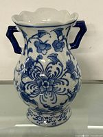 Front view of the porcelain vase showing overall floral pattern and handles.