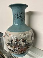Full view of the vase showing the full body with painted Chinese mountain landscape and waterfall scene with calligraphy on the upper neck.