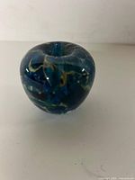 Front view of solid glass apple paperweight showing color pattern