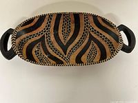 Top view showing full tribal design, oval shape, chevron rim, both handles
