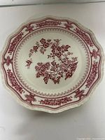 Front of Mason's ironstone plate showing red transfer floral design and scalloped rim