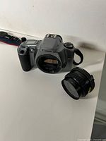 Front view of Canon EOS Rebel GII body with detached lens nearby