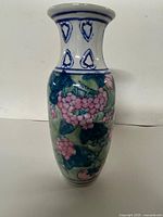 Full front view of vase showing grape design