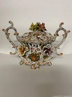 Front view showing tureen, handles, applied flowers