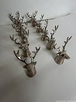 Group of all stag head napkin holders aligned on surface