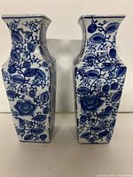 Front view of both square blue and white porcelain vases