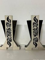 Front view showing both ceramic vases with floral motif and geometric base