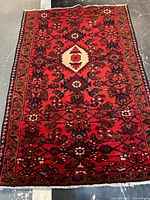 Full view of rectangular red Persian wool rug